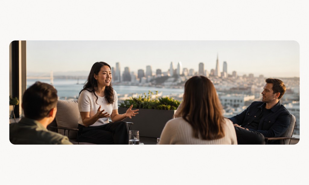 Founders sharing stories on a rooftop at sunset